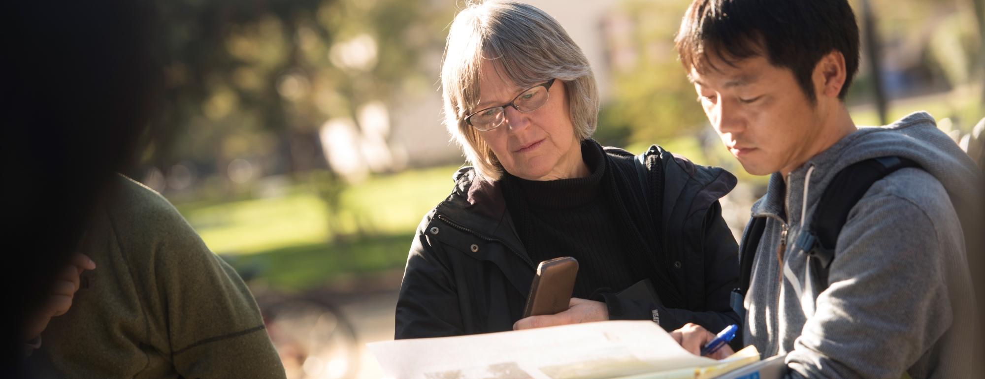  Sue Ebeler, vice dean with College of Agricultural and Environmental Sciences (glasses) shares a map with a student